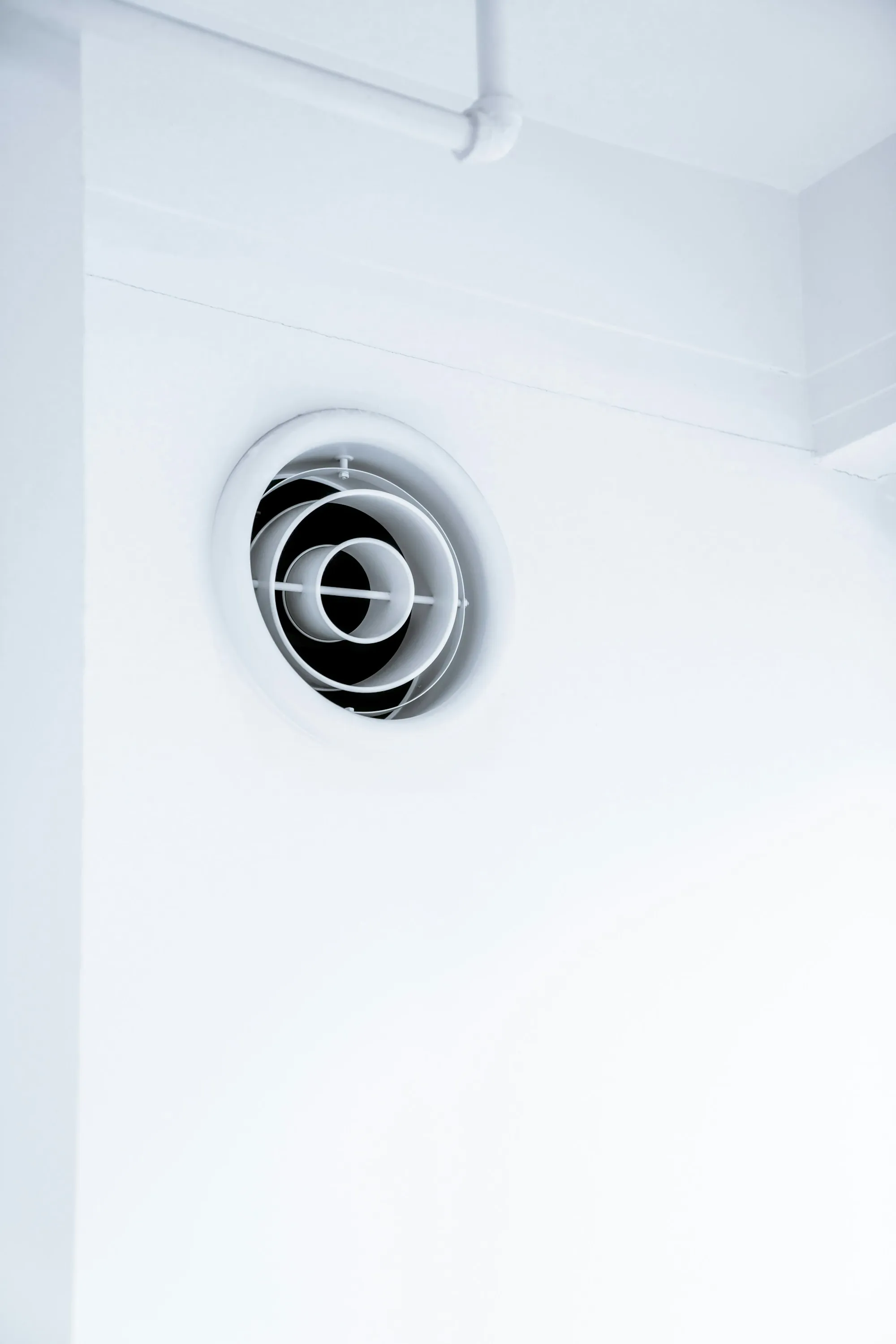 Round air vent on a white wall
